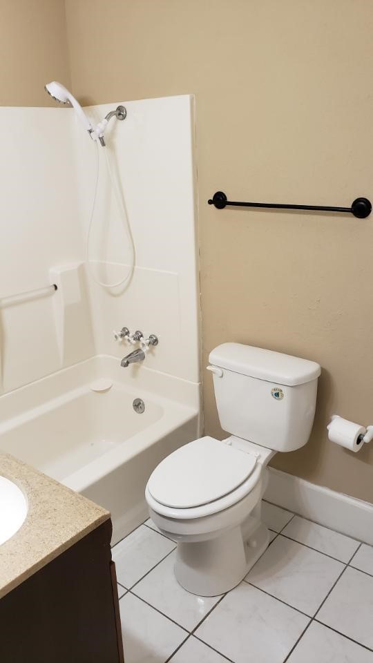 403 South 7th Street, Unit 1 Crockett, TX 75835 - Photo 2 of 8 a white toilet sitting next to a bath tub
