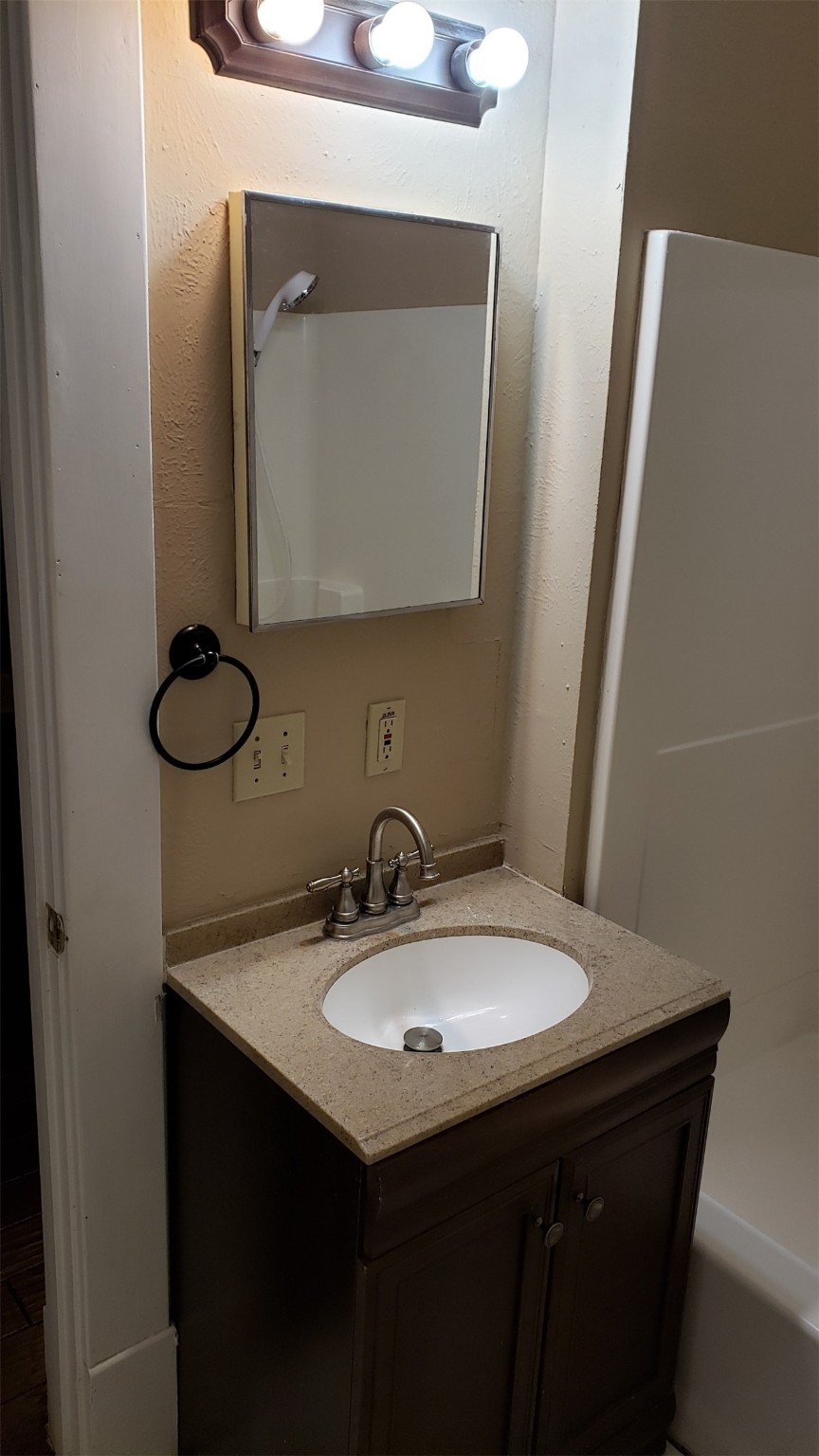 403 South 7th Street, Unit 1 Crockett, TX 75835 - Photo 3 of 8 a bathroom with a sink and a mirror