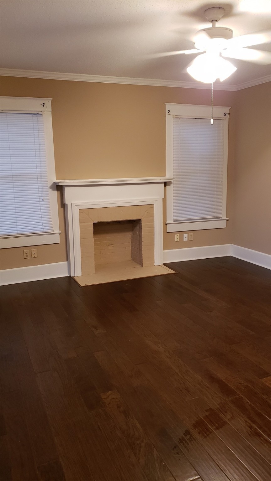 403 South 7th Street, Unit 1 Crockett, TX 75835 - Photo 7 of 8 a view of empty room with wooden floor and fireplace