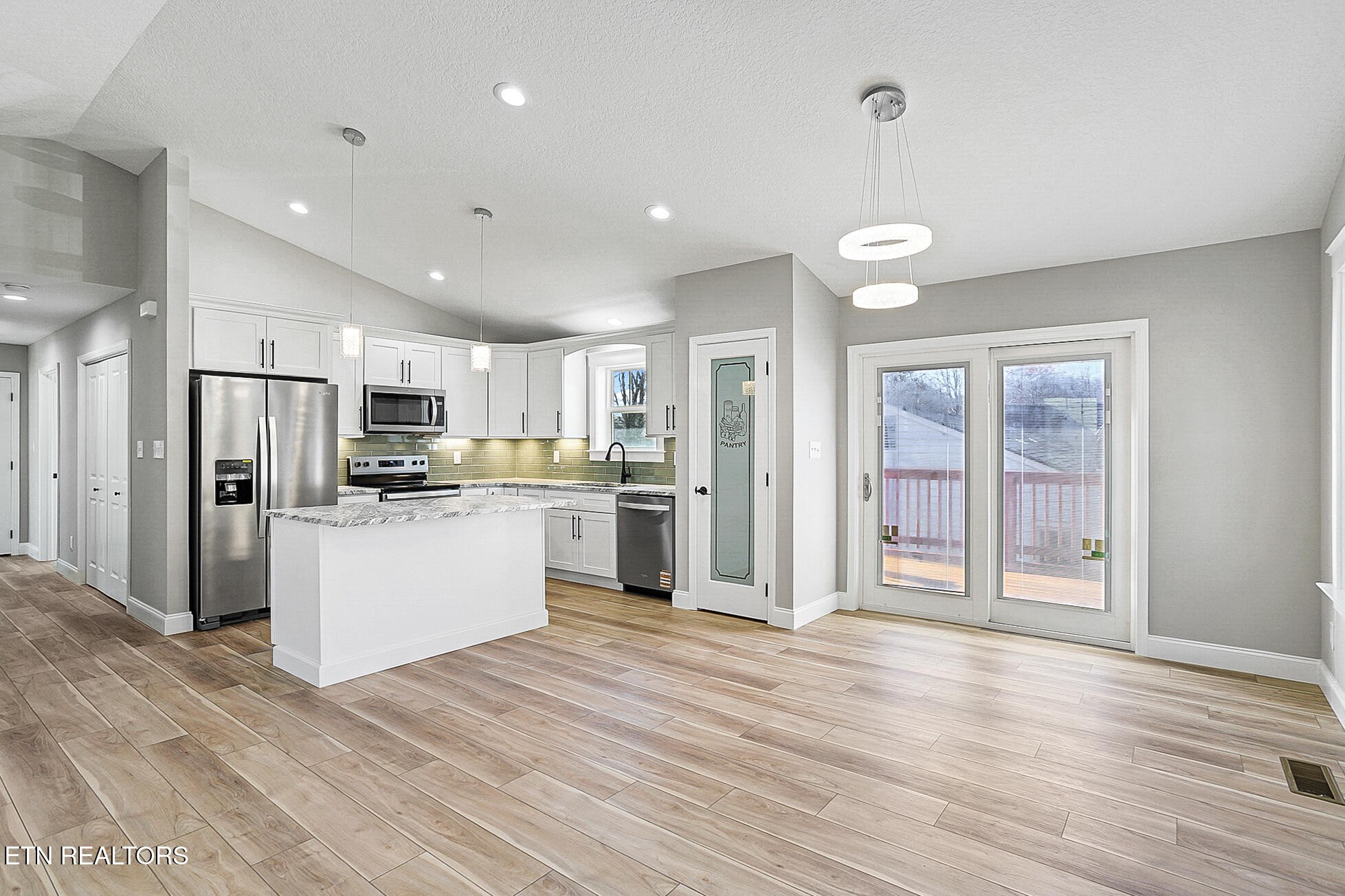 1134 Rider Avenue Knoxville, TN 37917 - Photo 13 of 44 a kitchen with white cabinets and stainless steel appliances