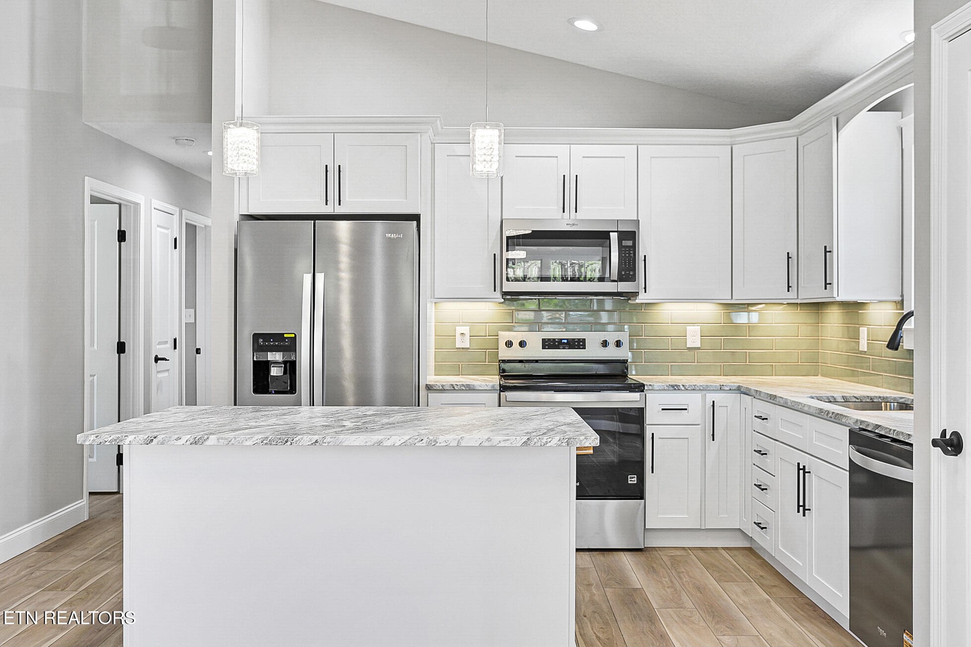 1134 Rider Avenue Knoxville, TN 37917 - Photo 15 of 44 a kitchen with stainless steel appliances a refrigerator sink and cabinets