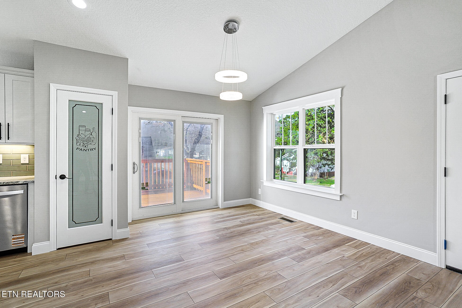 1134 Rider Avenue Knoxville, TN 37917 - Photo 21 of 44 an empty room with wooden floor and windows