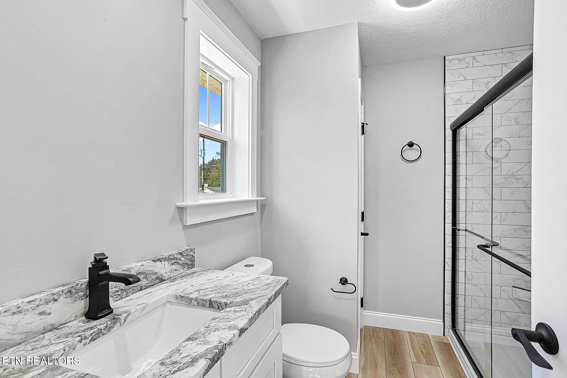 1134 Rider Avenue Knoxville, TN 37917 - Photo 28 of 44 a bathroom with a granite countertop sink toilet and shower