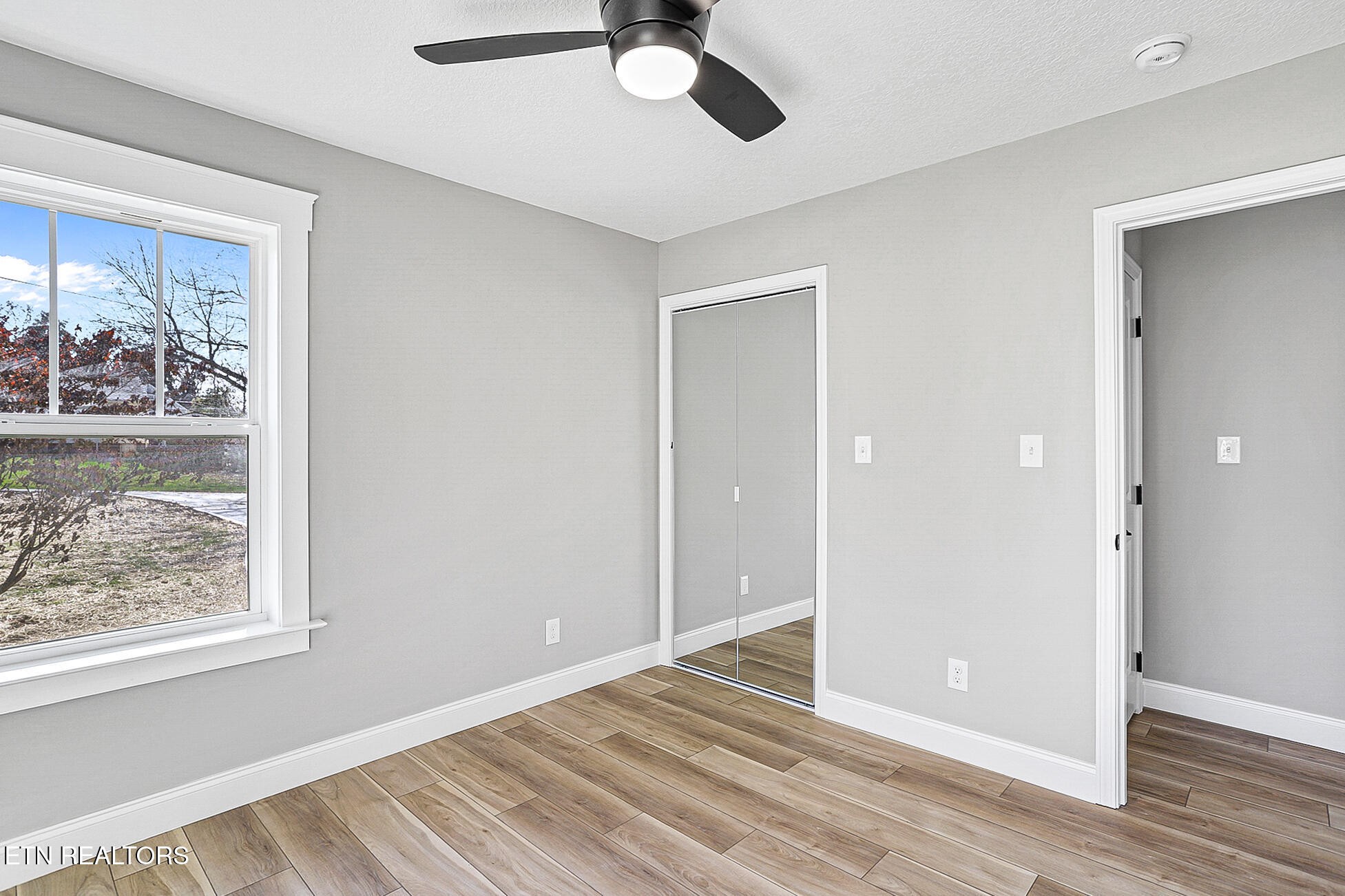 1134 Rider Avenue Knoxville, TN 37917 - Photo 32 of 44 a view of an empty room with window and wooden floor