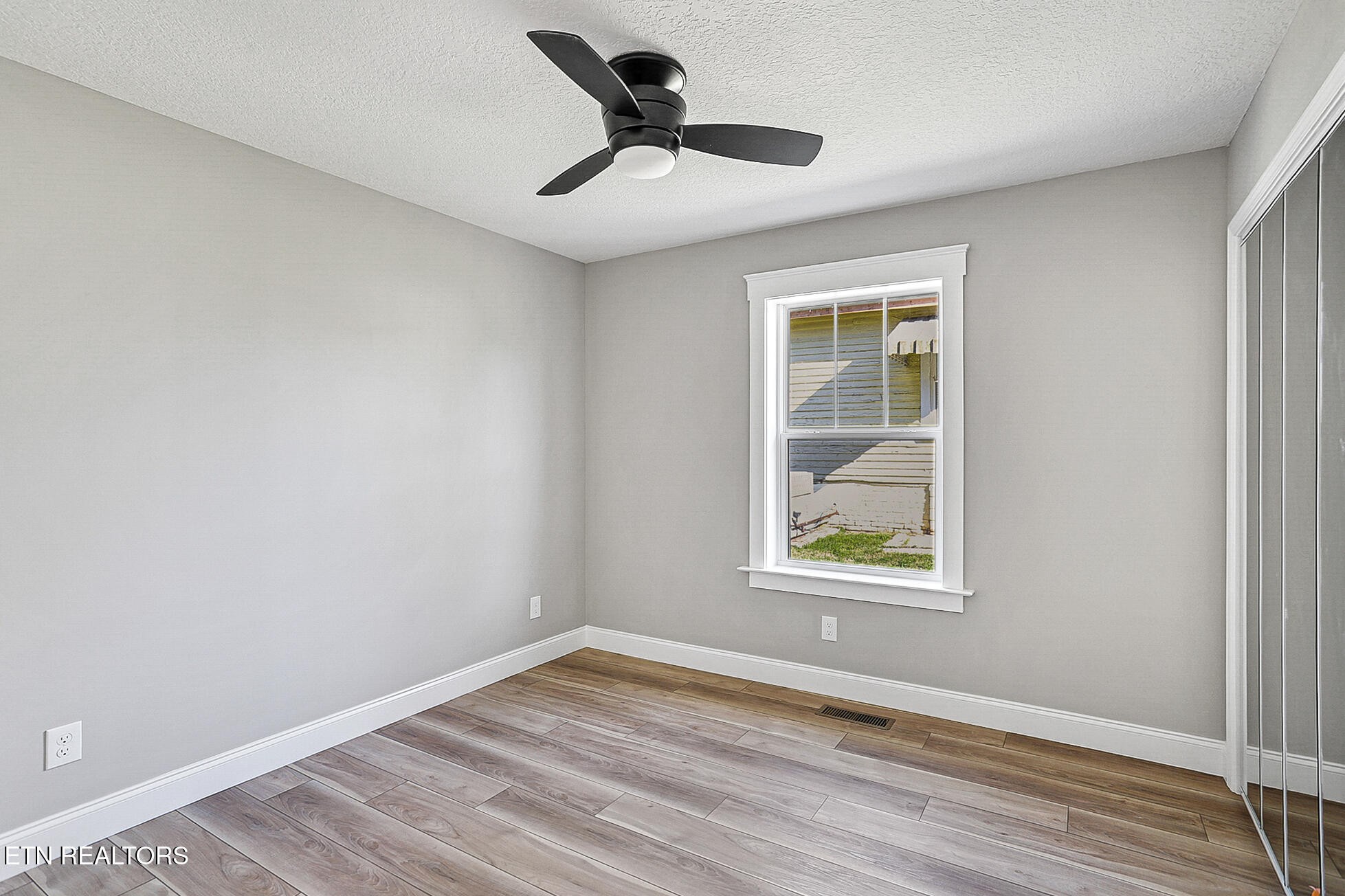 1134 Rider Avenue Knoxville, TN 37917 - Photo 36 of 44 a view of an empty room with a window and wooden floor