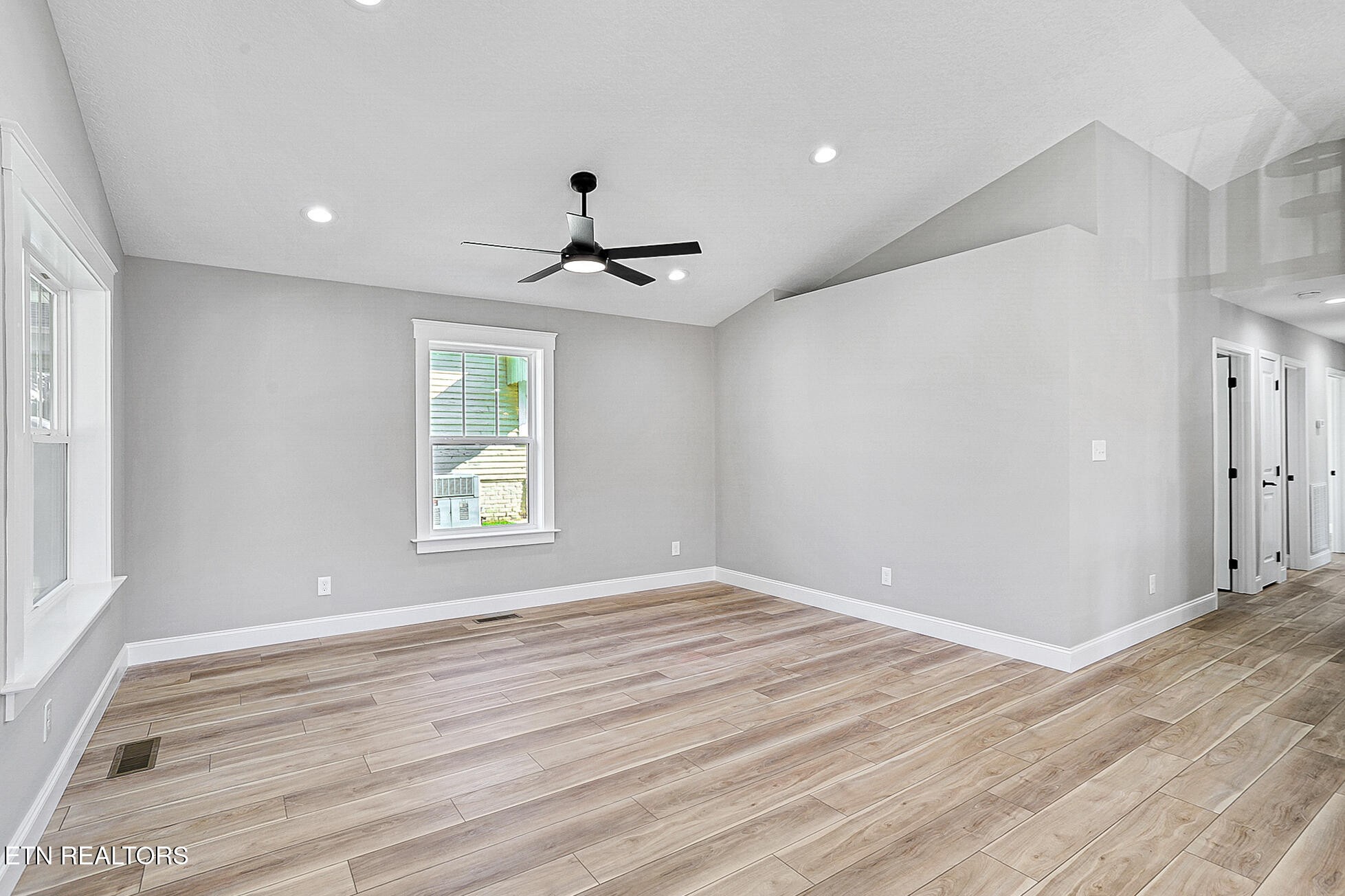 1134 Rider Avenue Knoxville, TN 37917 - Photo 6 of 44 a view of an empty room with wooden floor and a window