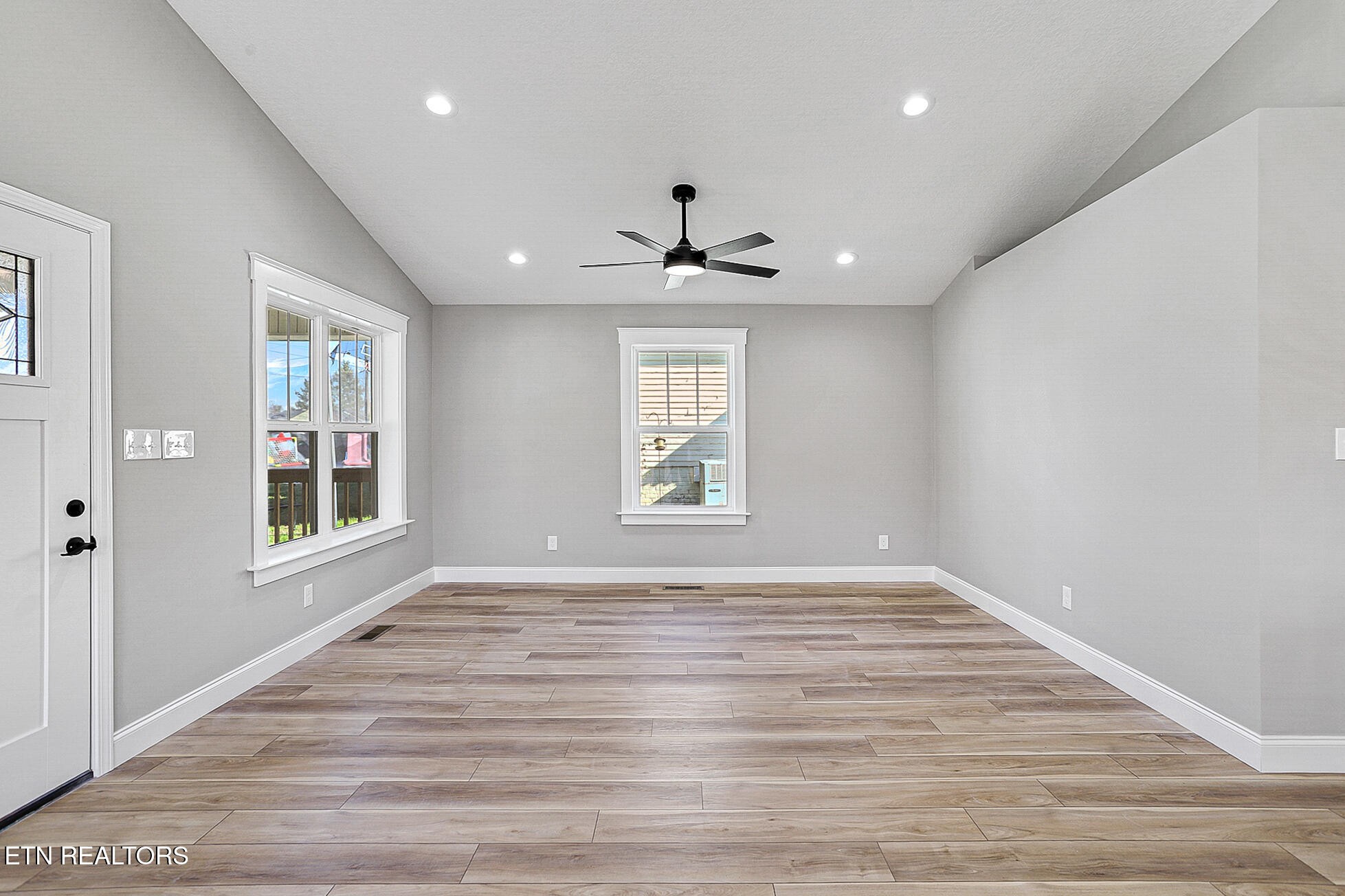 1134 Rider Avenue Knoxville, TN 37917 - Photo 7 of 44 a view of an empty room with a window and wooden floor