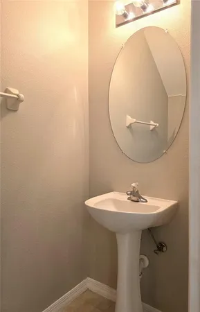 a bathroom with a sink a mirror and toilet