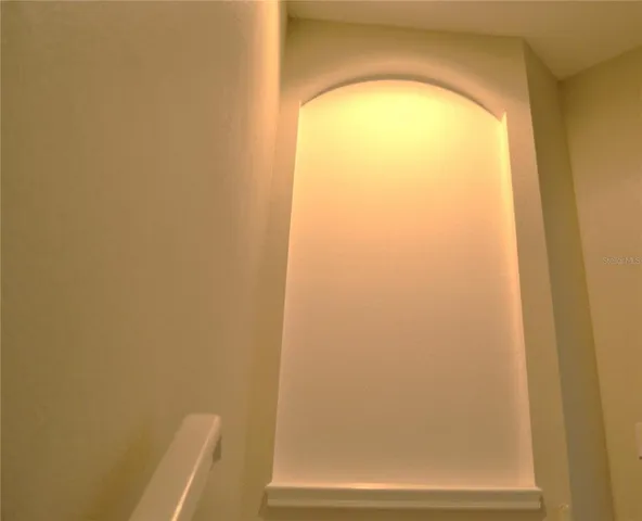 a bedroom with a bed window and wall painting