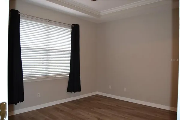 a bedroom with a bed window and wall painting