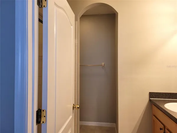 a white toilet sitting next to a white wall