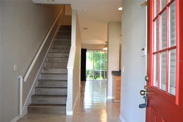 a view of staircase with white walls and windows