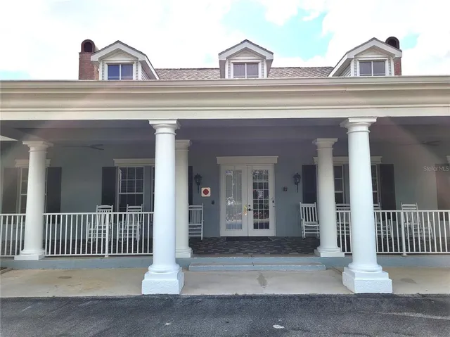 a front view of a house with a yard table and chairs