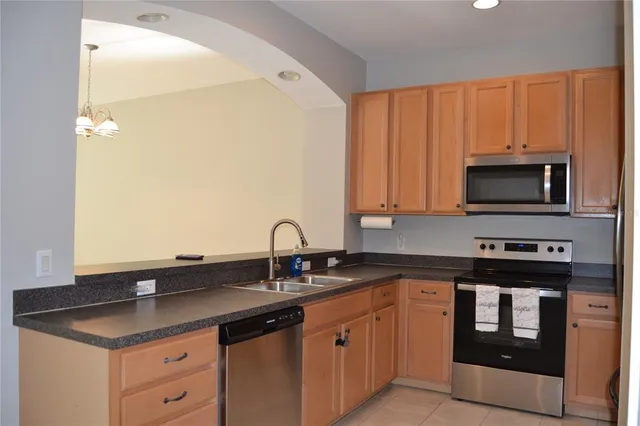 a kitchen with stainless steel appliances granite countertop a sink and a stove