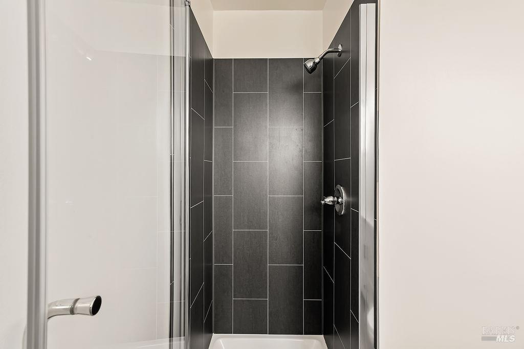 878 Pauline Court Santa Rosa, CA 95401 - Photo 16 of 36 a bathroom with a glass shower door