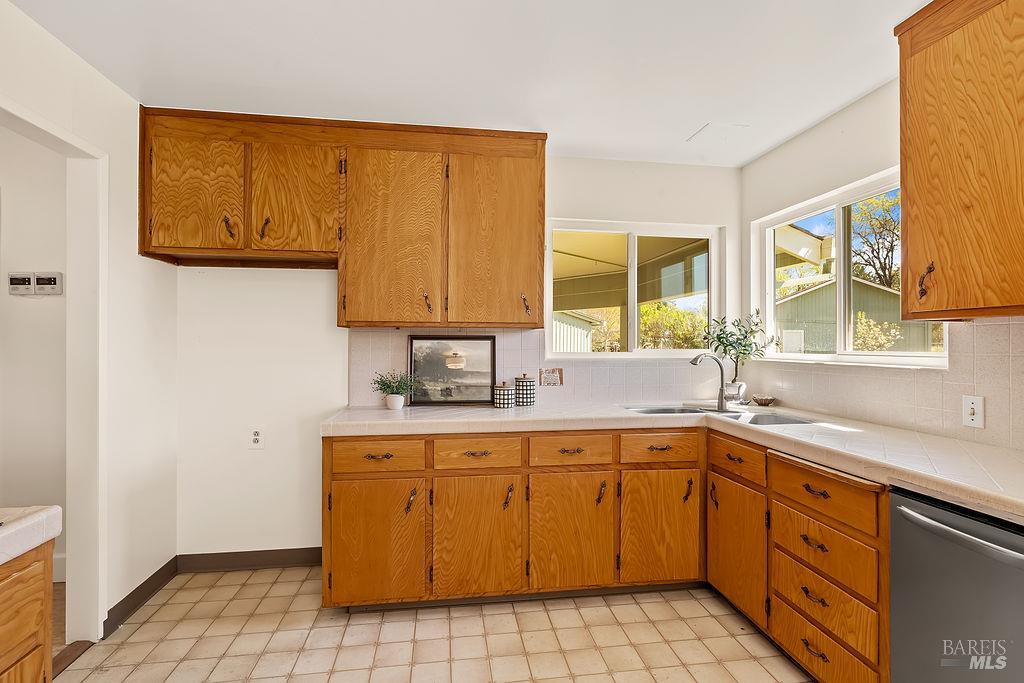 878 Pauline Court Santa Rosa, CA 95401 - Photo 10 of 36 a kitchen with a sink a stove cabinets and a window