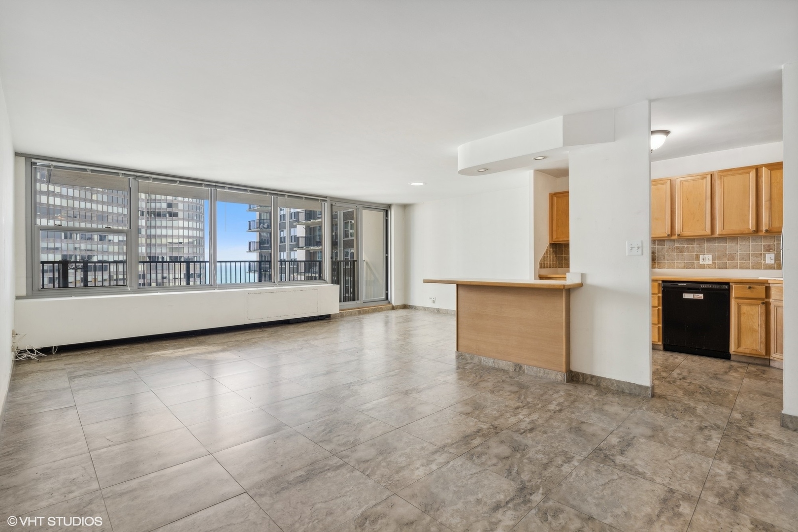 400 East Randolph Street, Unit 2525 Chicago, IL 60601 - Photo 2 of 23 a view of an empty room with a kitchen