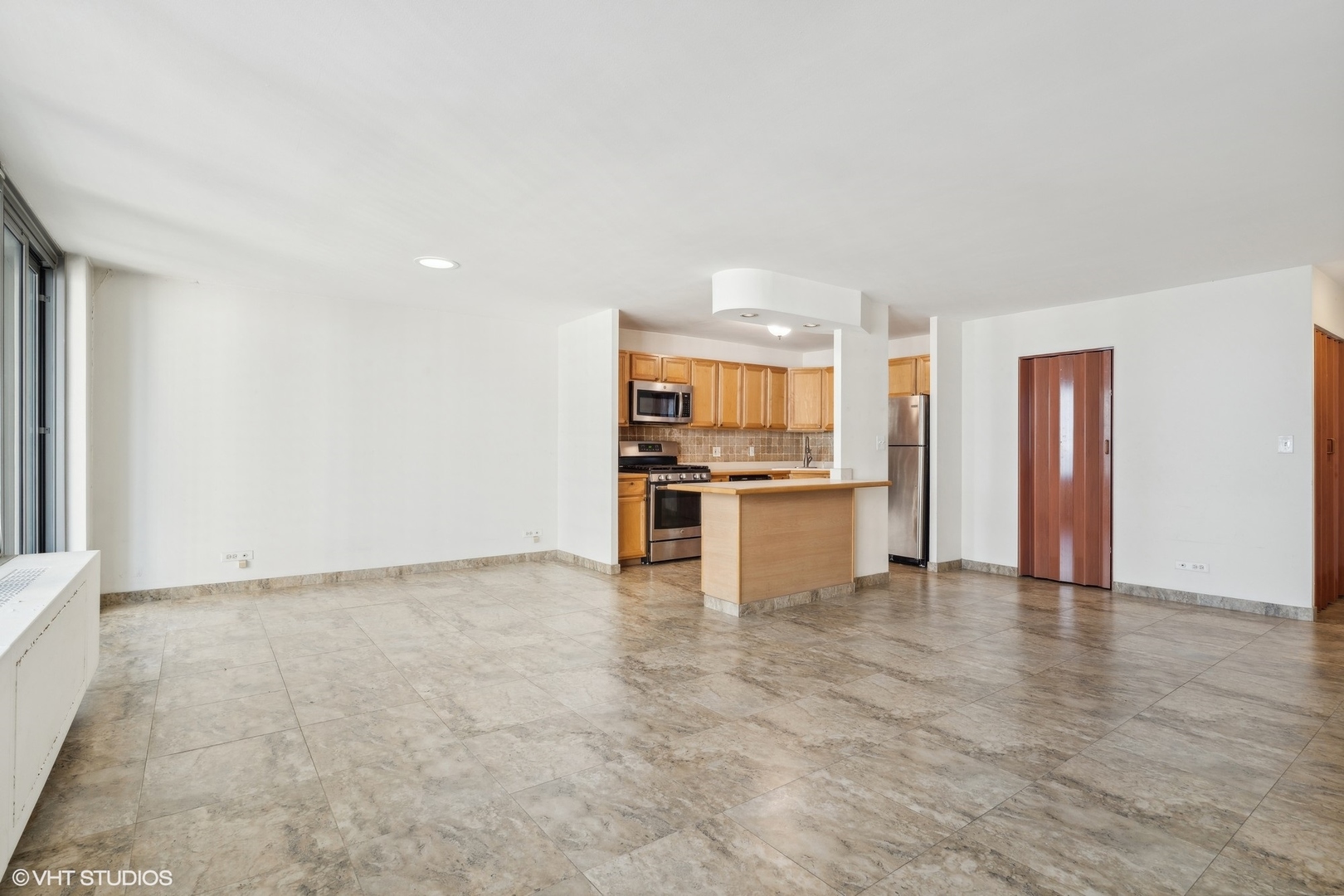 400 East Randolph Street, Unit 2525 Chicago, IL 60601 - Photo 4 of 23 a view of kitchen with refrigerator stove microwave and cabinets