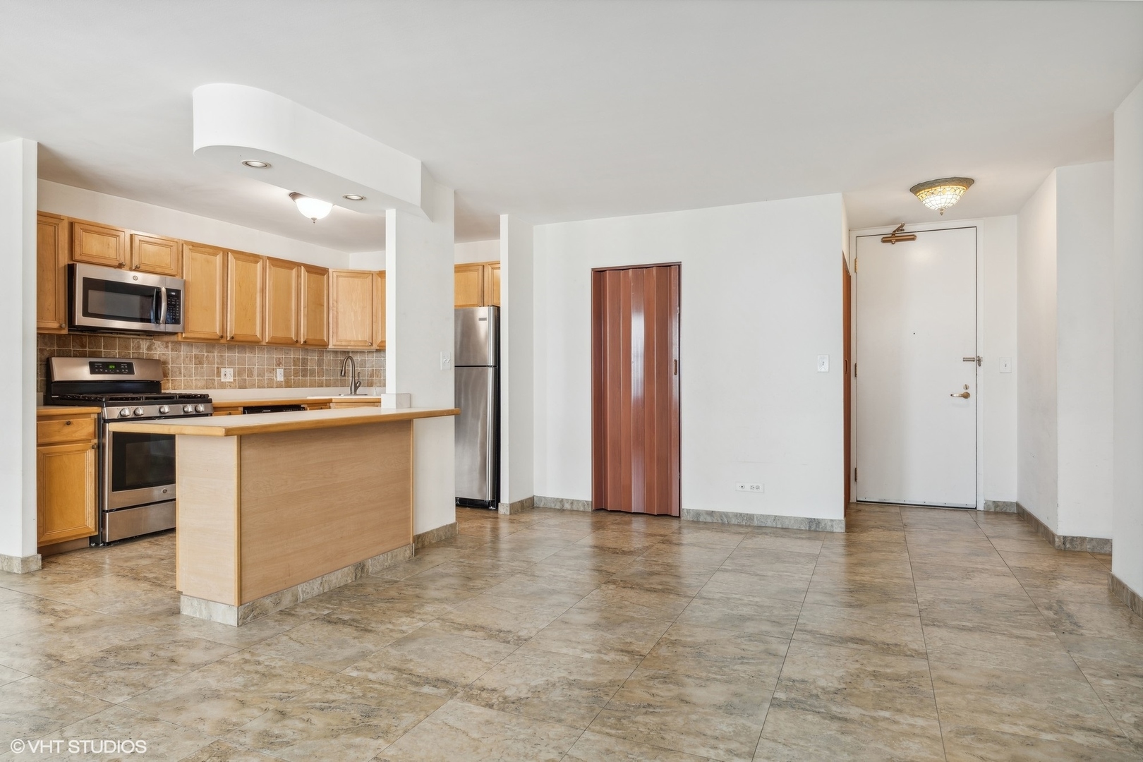 400 East Randolph Street, Unit 2525 Chicago, IL 60601 - Photo 6 of 23 a view of kitchen with stainless steel appliances granite countertop a stove top oven a sink and a refrigerator