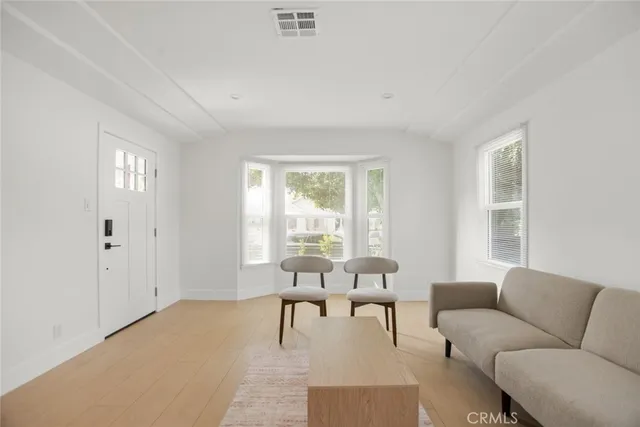 a view of a room with furniture and wooden floor