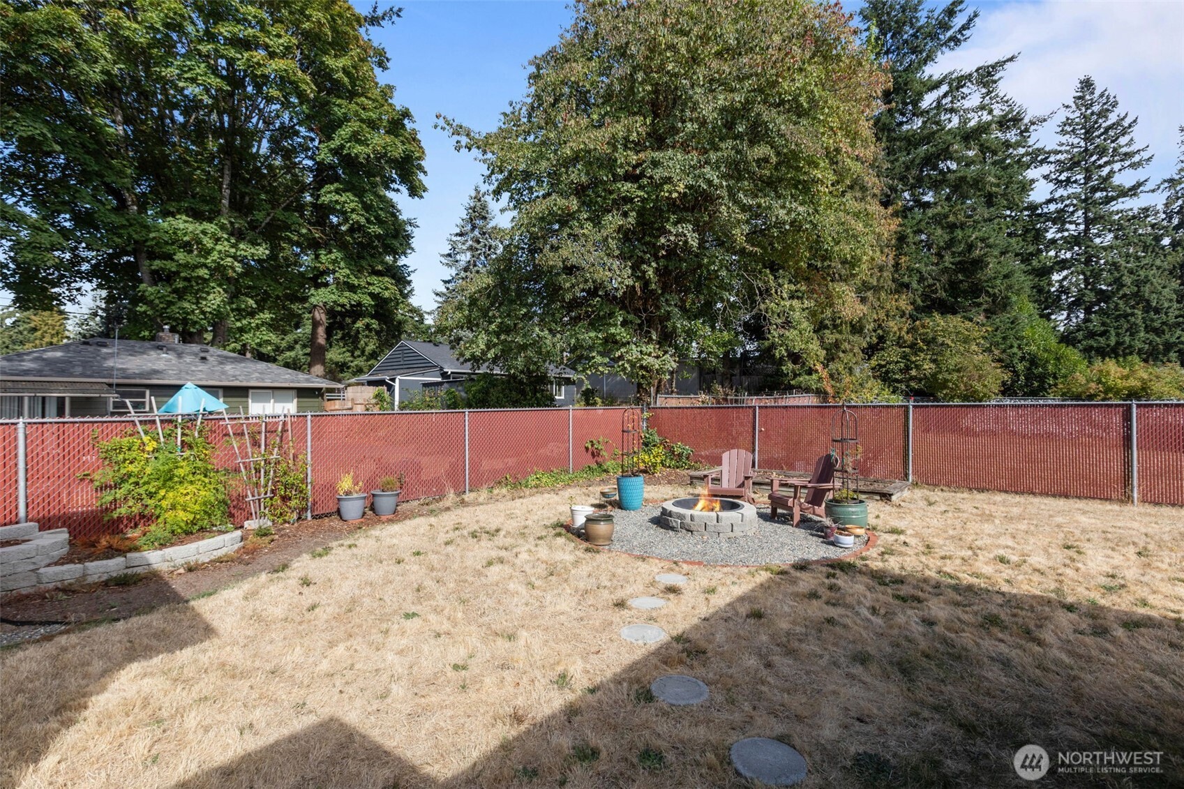 3610 Northeast 6th Street Renton, WA 98056 - Photo 26 of 33 a view of backyard with a table and chairs under an umbrella