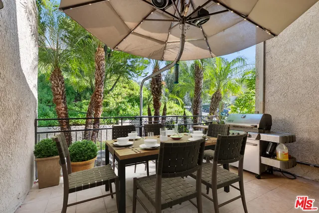 a view of an outdoor sitting area with furniture and umbrella