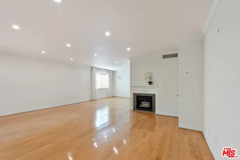 a view of an empty room with fire place