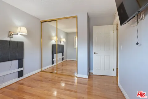 a view of a room with wooden floor and cabinet