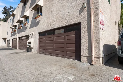 a view of a patio with a table and chairs under an umbrella