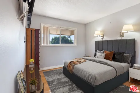 a bedroom with bed and a window