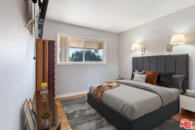 a bedroom with bed and a window