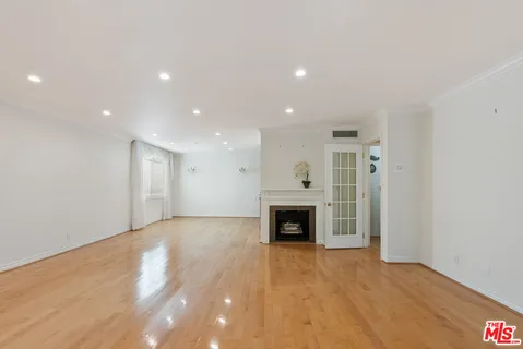 a view of an empty room with a fireplace