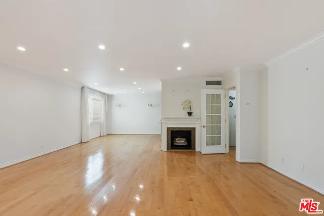 a view of an empty room with a fireplace
