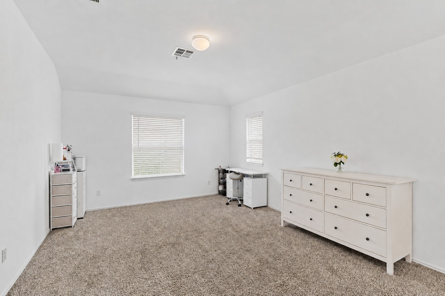 425 Perfect World Loop Jarrell, TX 76537 - Photo 17 of 28 A spacious room offers ample natural light and plush carpeting, ideal for an office or additional bedroom.