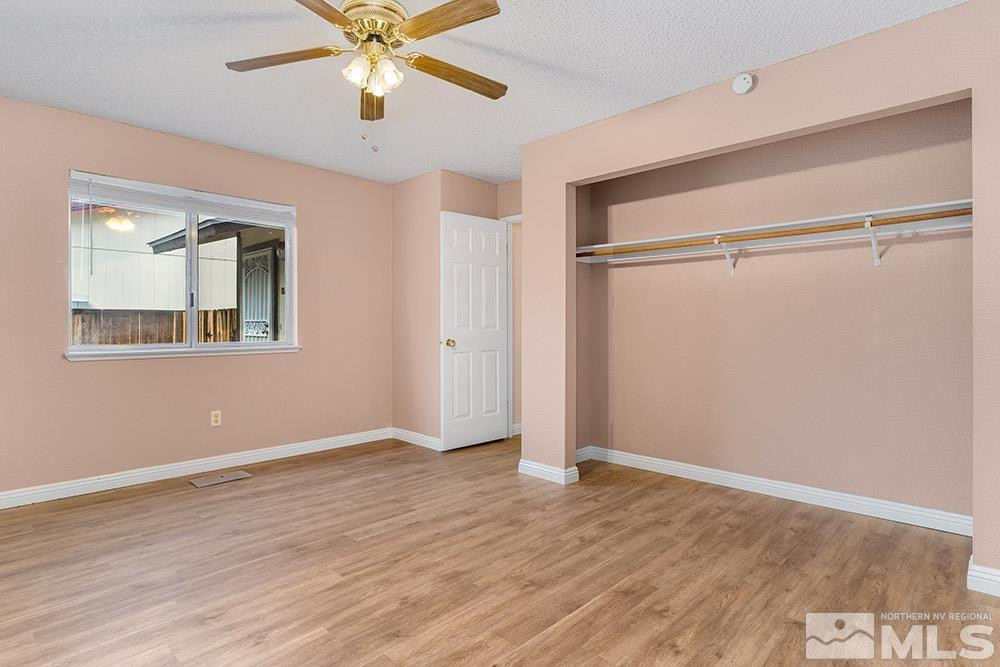 6455 Lotus Street Reno, NV 89506 - Photo 8 of 25 a view of an empty room with wooden floor and a ceiling fan