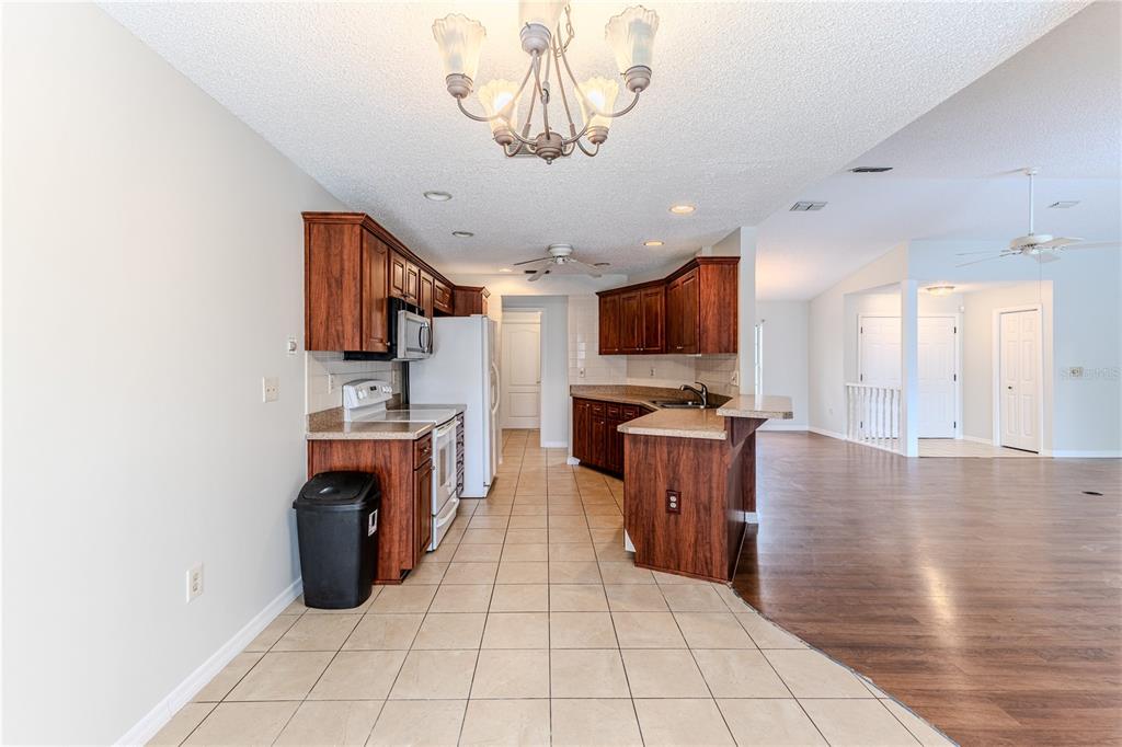 2489 Amherst Avenue Spring Hill, FL 34609 - Photo 15 of 45 a large kitchen with cabinets and stainless steel appliances