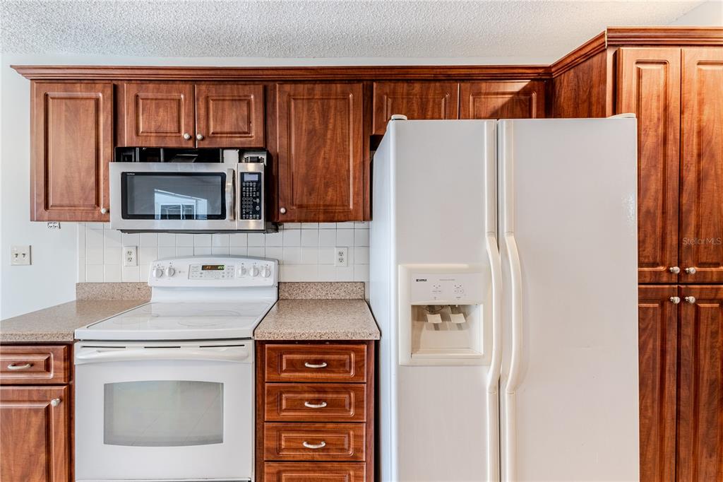 2489 Amherst Avenue Spring Hill, FL 34609 - Photo 17 of 45 a kitchen with a refrigerator sink and microwave