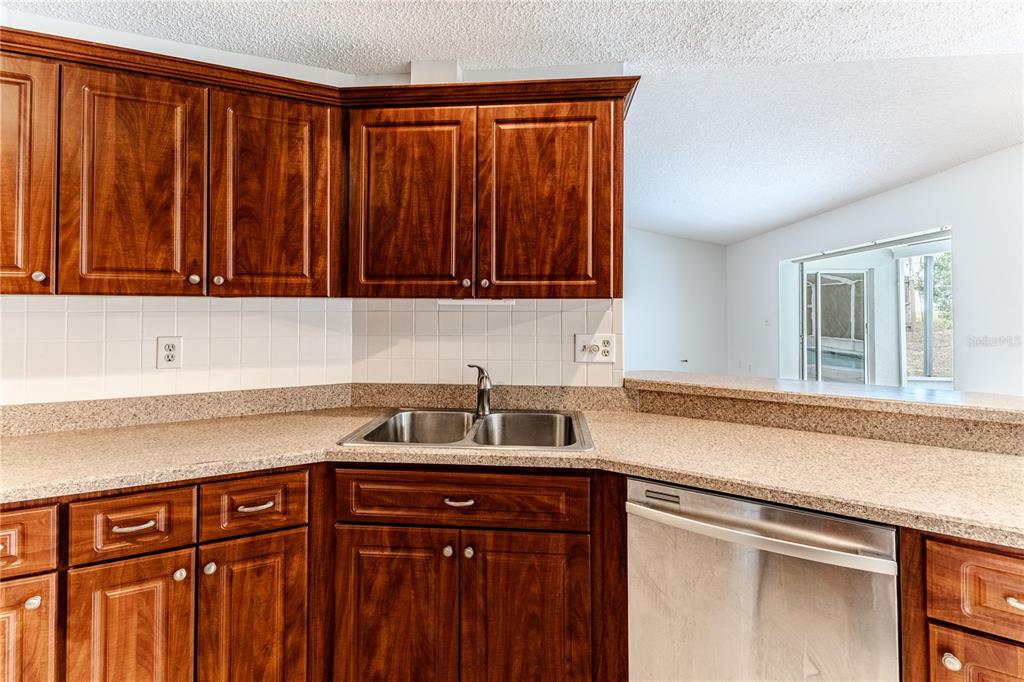 2489 Amherst Avenue Spring Hill, FL 34609 - Photo 18 of 45 a kitchen with a sink cabinets and a window
