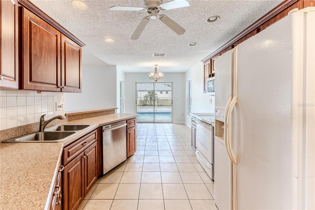 2489 Amherst Avenue Spring Hill, FL 34609 - Photo 19 of 45 a kitchen with a sink stove and refrigerator