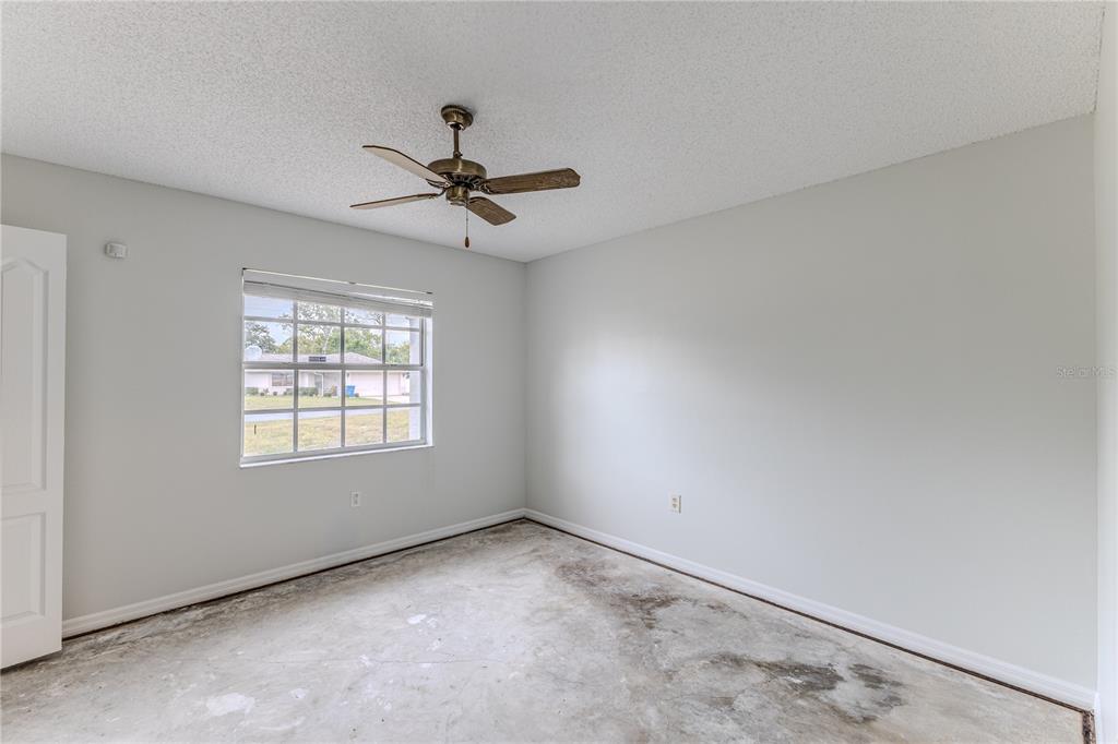 2489 Amherst Avenue Spring Hill, FL 34609 - Photo 20 of 45 a view of an empty room with a window