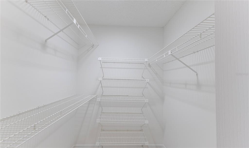 2489 Amherst Avenue Spring Hill, FL 34609 - Photo 33 of 45 a view of walk in closet with empty racks