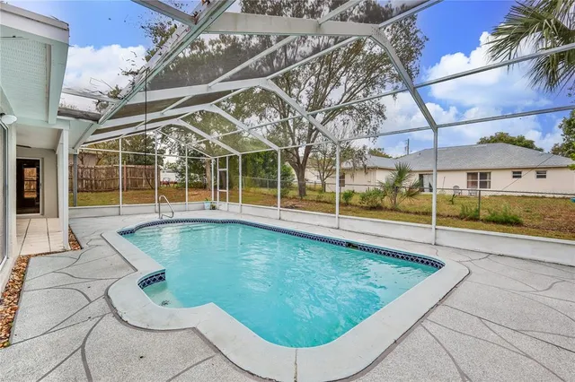 a view of a swimming pool with a patio