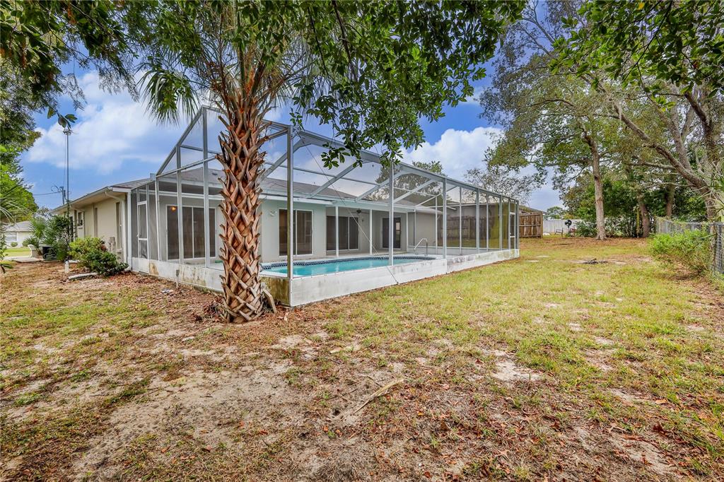 2489 Amherst Avenue Spring Hill, FL 34609 - Photo 40 of 45 a house with trees in front of it