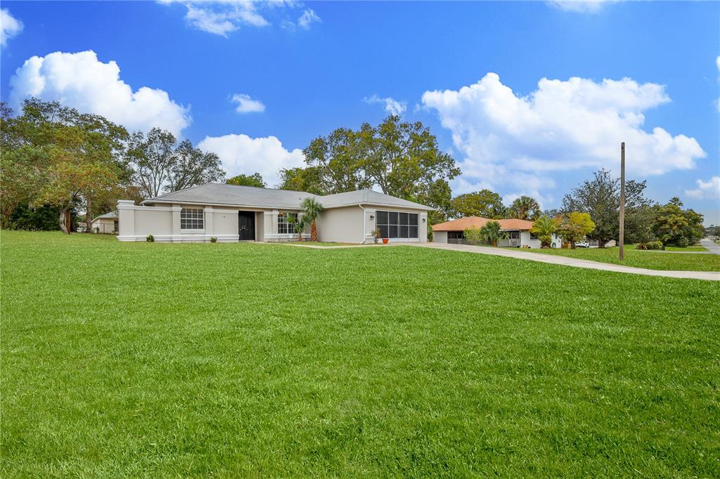 2489 Amherst Avenue Spring Hill, FL 34609 - Photo 4 of 45 a view of a house with a yard