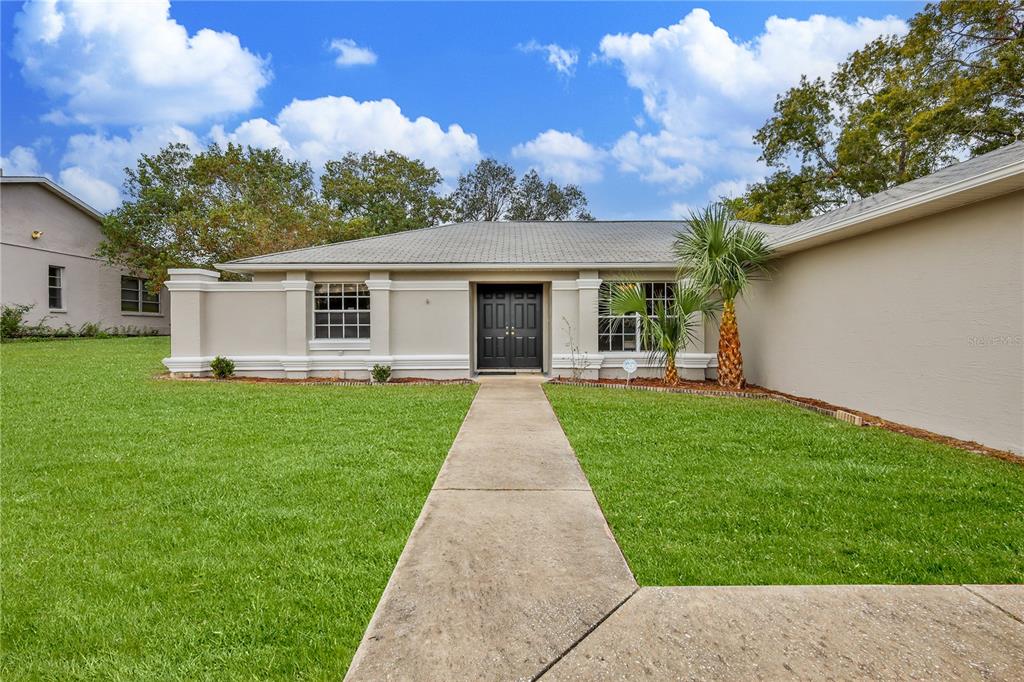 2489 Amherst Avenue Spring Hill, FL 34609 - Photo 7 of 45 front view of a house with a yard
