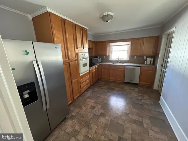 a kitchen with refrigerator a sink dishwasher a refrigerator and a stove