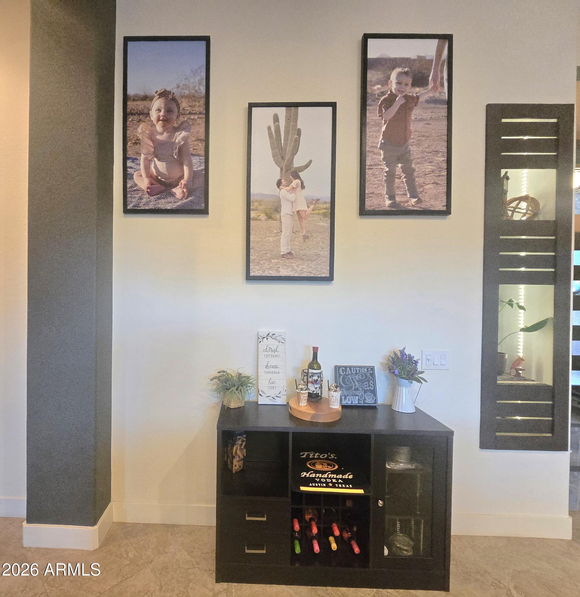 9156 West Bajada Road Peoria, AZ 85383 - Photo 11 of 88 a room with a painting on the wall and a stove