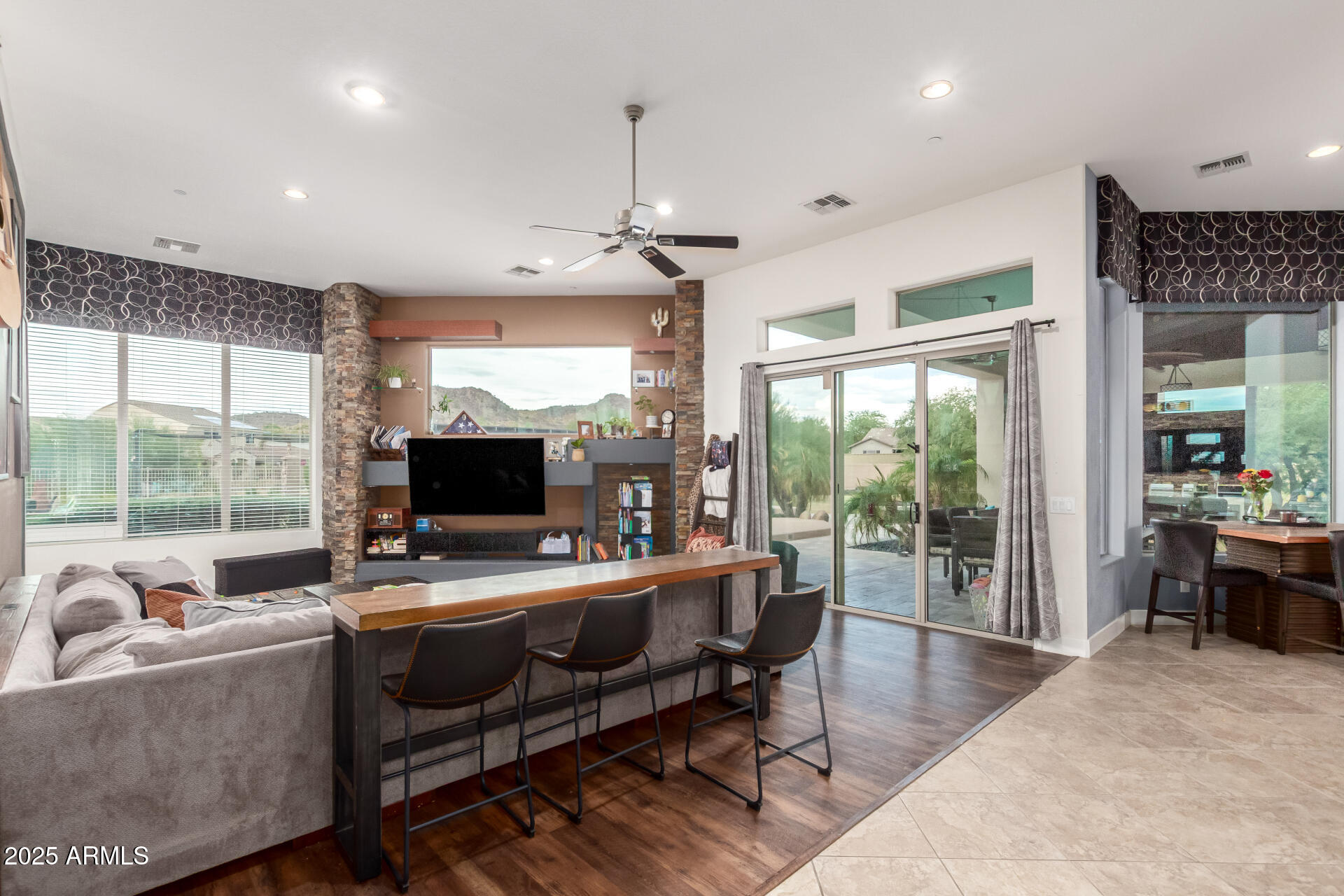 9156 West Bajada Road Peoria, AZ 85383 - Photo 13 of 97 a living room with furniture a large window and a fireplace