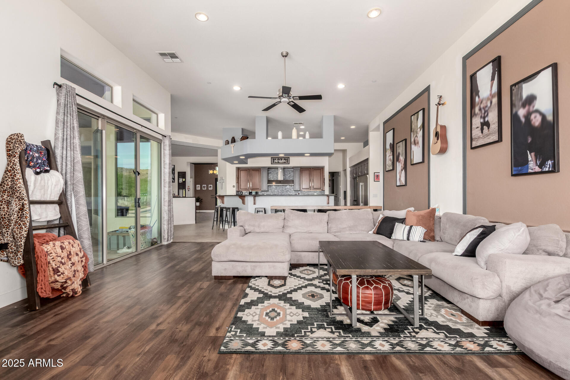 9156 West Bajada Road Peoria, AZ 85383 - Photo 24 of 88 a living room with furniture or couch and a chandelier