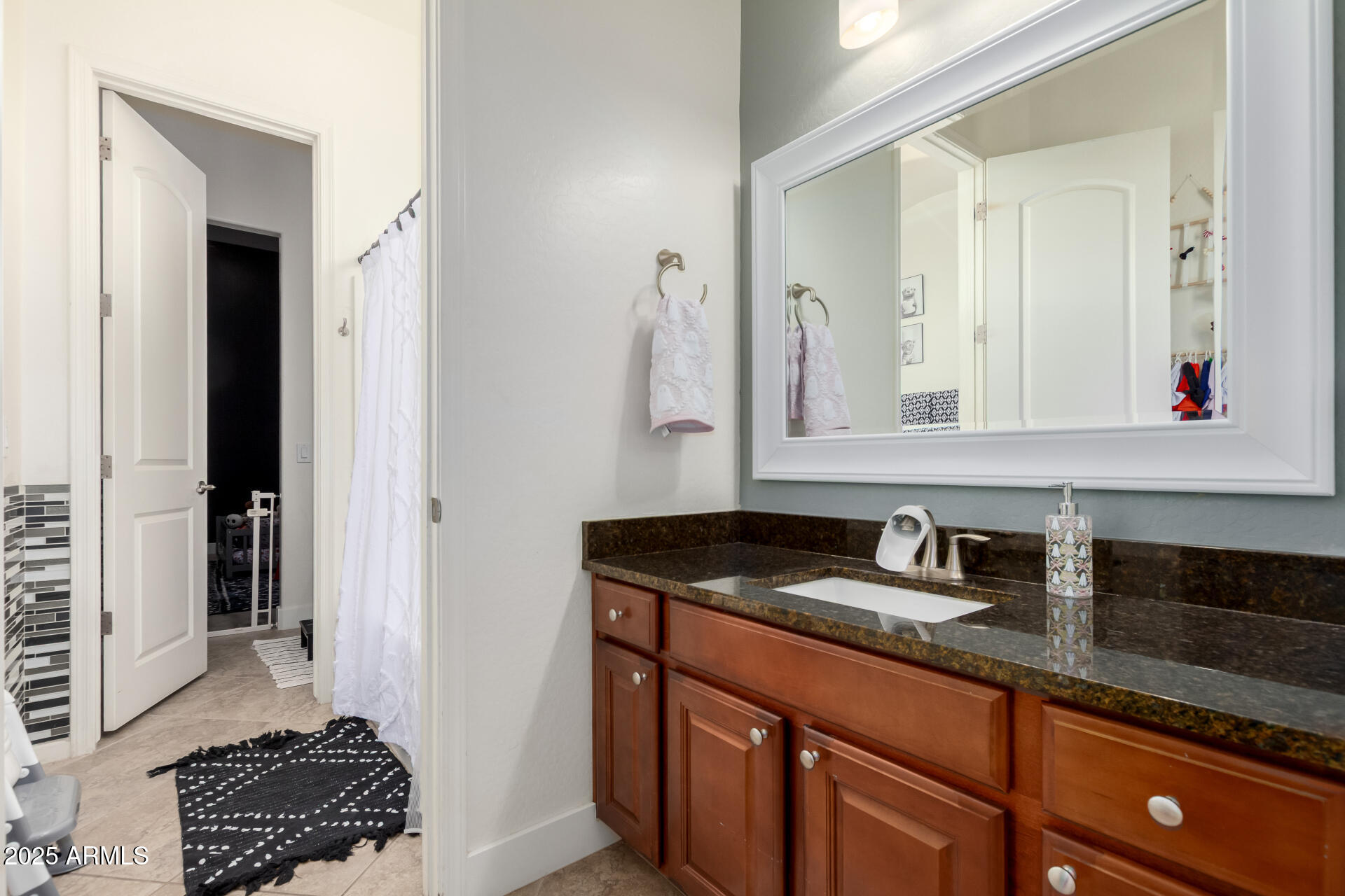 9156 West Bajada Road Peoria, AZ 85383 - Photo 31 of 88 a bathroom with a sink and a mirror